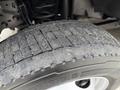 Close-up of a worn tire from a 2020 Ford F-550 showing significant tread wear and debris on the surface