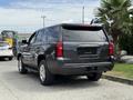 A gray 2017 Chevrolet Tahoe parked showing its rear and side features with a sleek design and alloy wheels
