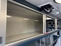 Interior shelving of a 2020 Mercedes-Benz Sprinter 2500 featuring multiple compartments and a sleek design