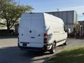 A 2016 Mercedes-Benz Sprinter van in white with a high roof and rear doors parked in a lot