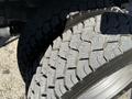 Close-up of the rugged tread pattern on a 2010 Ford F-450 tire showcasing its deep grooves and robust design for traction and durability