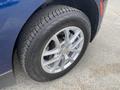 Close-up of a silver alloy wheel and tire of a 2022 Chevrolet Equinox showing tread pattern and brand markings
