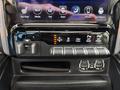 The interior controls of a 2021 RAM 1500 featuring climate settings and various driving mode switches