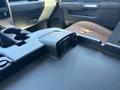 A 2015 RAM 1500 interior with a close-up view of the center console featuring a charging dock and storage compartments