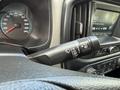 Close-up of the steering column in a 2018 Chevrolet Colorado showing the windshield wiper controls and dashboard gauge with a speedometer