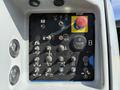 Control panel of a 2012 Genie Z 45/25 featuring various switches buttons and indicators for operational functions