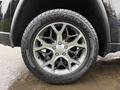 A 2019 Jeep Grand Cherokee wheel featuring a five-spoke silver alloy rim with a Scorpion ATR tire mounted on it