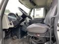 Interior of a 2014 International Durastar featuring a steering wheel and driver's seat with controls and instrument panel visible