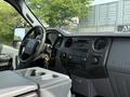 Interior view of a 2011 Ford F-350 SD featuring a steering wheel dashboard and center console with controls and a gear shift