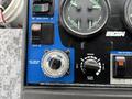 Control panel of a 2009 UD Trucks UD 3300 featuring dials for broom position and pressure as well as engine speed settings