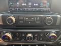 The dashboard controls of a 2017 Chevrolet Silverado 1500 featuring radio media and climate control buttons with knobs