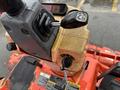 Close-up of the control panel of a 2012 Kubota F3680 featuring a joystick lever and a key ignition with various switches and dials