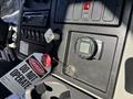 The interior dashboard of a 2013 International 7500 featuring a digital display monitor and several control buttons with a warning tag that reads DO NOT OPERATE