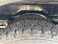 Close-up of a heavily treaded tire from a 2020 Chevrolet Express showing textured surface and details of the tire's rubber compound