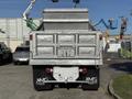 A 2017 Ford F-650 Super Duty truck with an aluminum dump bed is parked facing forward showing its rear and tailgate design