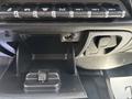 Interior view of a 2020 Chevrolet Silverado showing the dashboard with buttons for various functions and an open compartment below