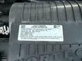 2019 Chevrolet Express engine with a vehicle emission control information label attached to the engine cover