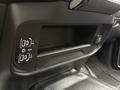 A storage compartment in the dashboard of a 2024 RAM 5500 with two USB ports and an auxiliary input clearly visible