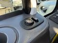Close-up of the control panel for a 2017 International 4300 featuring a circular switch and a button for power windows or mirrors