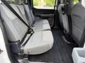 Interior view of a 2021 Ford F-150 showing the backseat with two rows of gray seats each equipped with seatbelts