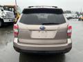 A 2016 Subaru Forester viewed from the rear with a simple design and minimal features visible on the back including the logo and model name