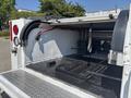 A 2017 Chevrolet Colorado with a view of its open truck bed showing a flat floor and storage area with various fittings and equipment visible inside