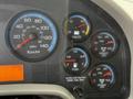 A dashboard of a 2012 International 4300 displaying speedometer fuel gauge voltmeter air brake pressure and other indicators