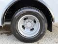 A close-up of a tire mounted on a silver wheel from a 2019 Chevrolet Express displaying the tire tread pattern and wheel lug nuts
