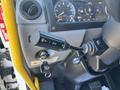 A close-up of the control lever of a 2022 Lion Lion6 featuring various buttons for vehicle functions and a key ignition slot visible in the foreground
