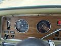 Dashboard of a 1976 GMC Motorhome featuring a speedometer fuel gauge and various control knobs