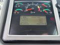 Close-up of a digital display panel from a Caterpillar 980 loader showing various gauges and lifetime totals such as weight, load count, and hours operated