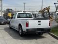 A white 2008 Ford F-250 Super Duty pickup truck is parked with its tailgate down showing the truck bed and rearview. The truck has a crew cab configuration