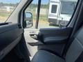 Interior view of a 2016 Mercedes-Benz Sprinter showing the driver's side dashboard and door panel with a rearview mirror