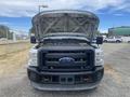 A 2014 Ford F-350 SD with the hood raised revealing the engine compartment