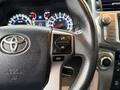 Close-up of a 2018 Toyota 4Runner steering wheel showing controls for display settings and audio functions