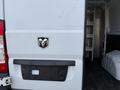 The rear of a 2017 RAM Promaster showing the RAM logo in the center above a black license plate holder