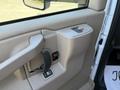 Interior door panel of a 2024 Chevrolet Express featuring a handle window control and lock button