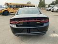 A black 2019 Dodge Charger viewed from the rear showcasing its sleek design and distinctive taillights