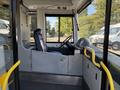 Interior view of a 2016 Grande West Vicinity bus featuring the driver's seat steering wheel and control panel with yellow handrails visible
