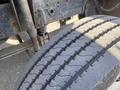 Close-up of a worn tire on a 1996 GMC Top Kick showcasing its tread pattern and rubber texture