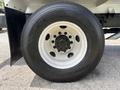 Close-up of a 2016 Ford F-750 wheel featuring a black tire with a white rim and multiple bolts for mounting