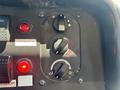 Control panel of a 2012 Ford Econoline featuring dials for temperature and airflow with indicator lights