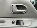 Close-up of the door panel of a 2008 International CityStar featuring a door handle and window controls in a textured gray material