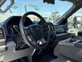 Interior view of a 2019 Ford F-550 featuring a steering wheel dashboard controls and center console