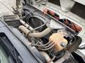 The engine compartment of a 2012 International 7400 showing various engine components including hoses and reservoirs