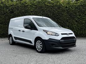 A white 2014 Ford Transit Connect van with black accents and alloy wheels parked at an angle