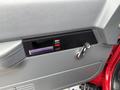 The interior door panel of a 2002 GMC C7500 featuring a handle a rectangular window control and a small button