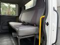 Interior view of a 2012 International 4300 showing the passenger seat with grey fabric and seatbelts attached