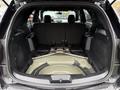 The interior of a 2019 Ford Explorer with spacious cargo area visible and the back seats folded down