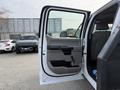 Interior view of a 2020 Ford F-550 truck door open displaying gray fabric and plastic features including the door handle and window controls